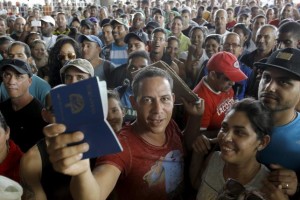 A Cuban migrant man receives his passport with the visa granted by the immigration office at the border post with Panama in Paso Canoas